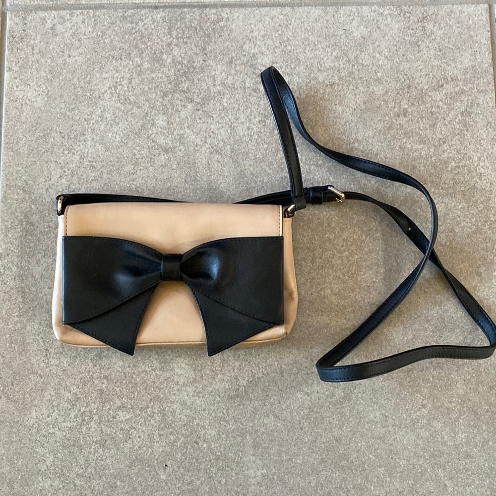 Kate Spade tan clutch with black bow